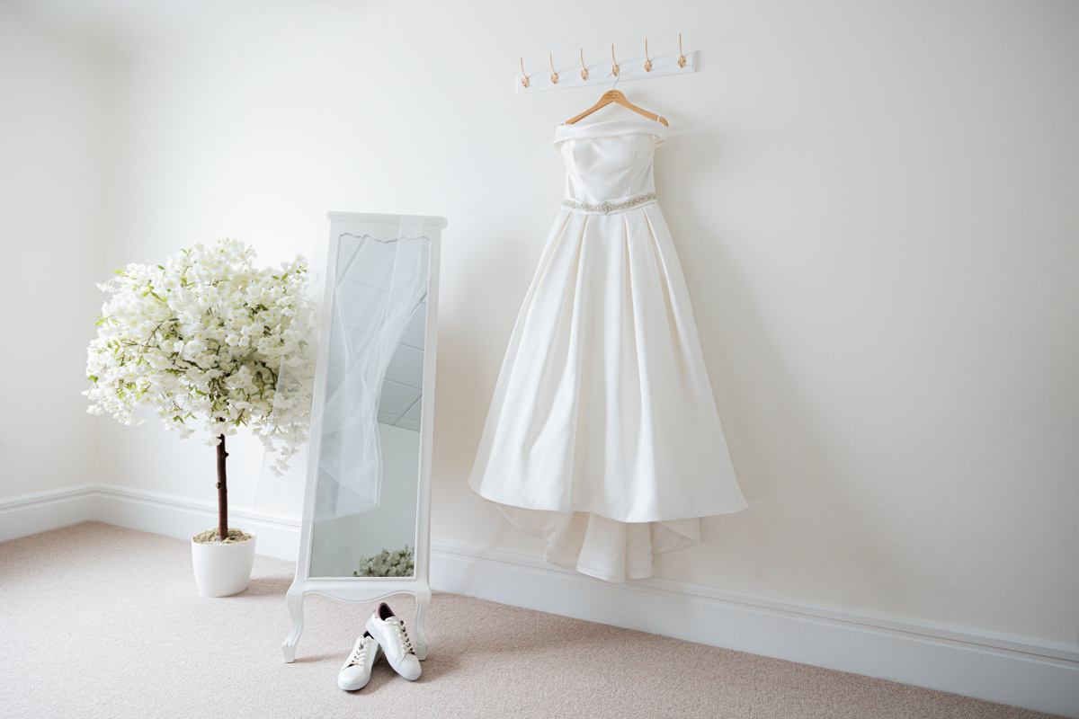 dress hanging in getting ready room photographed by Arley House and Gardens Wedding Photographer