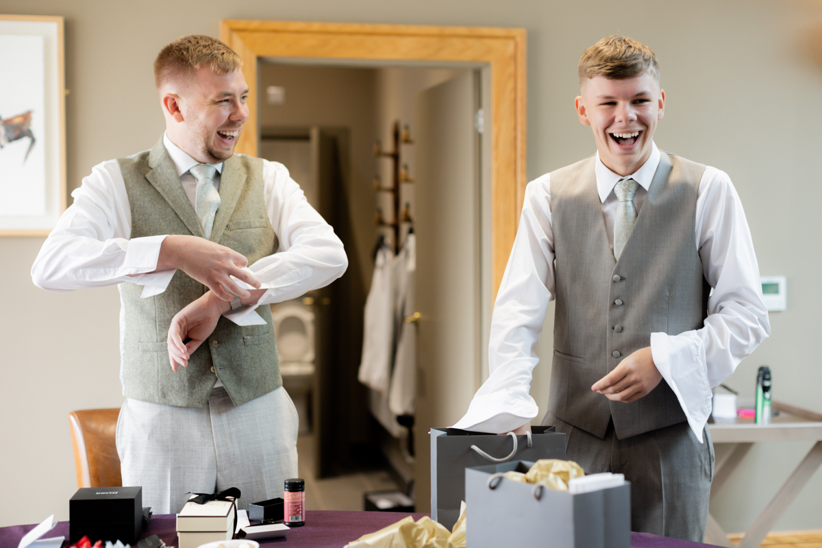 groom and friend laughing getting ready at Arley House & Gardens