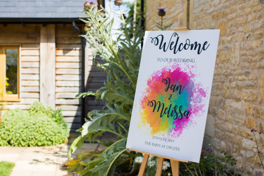 colourful wedding welcome sign at the barn at upcote