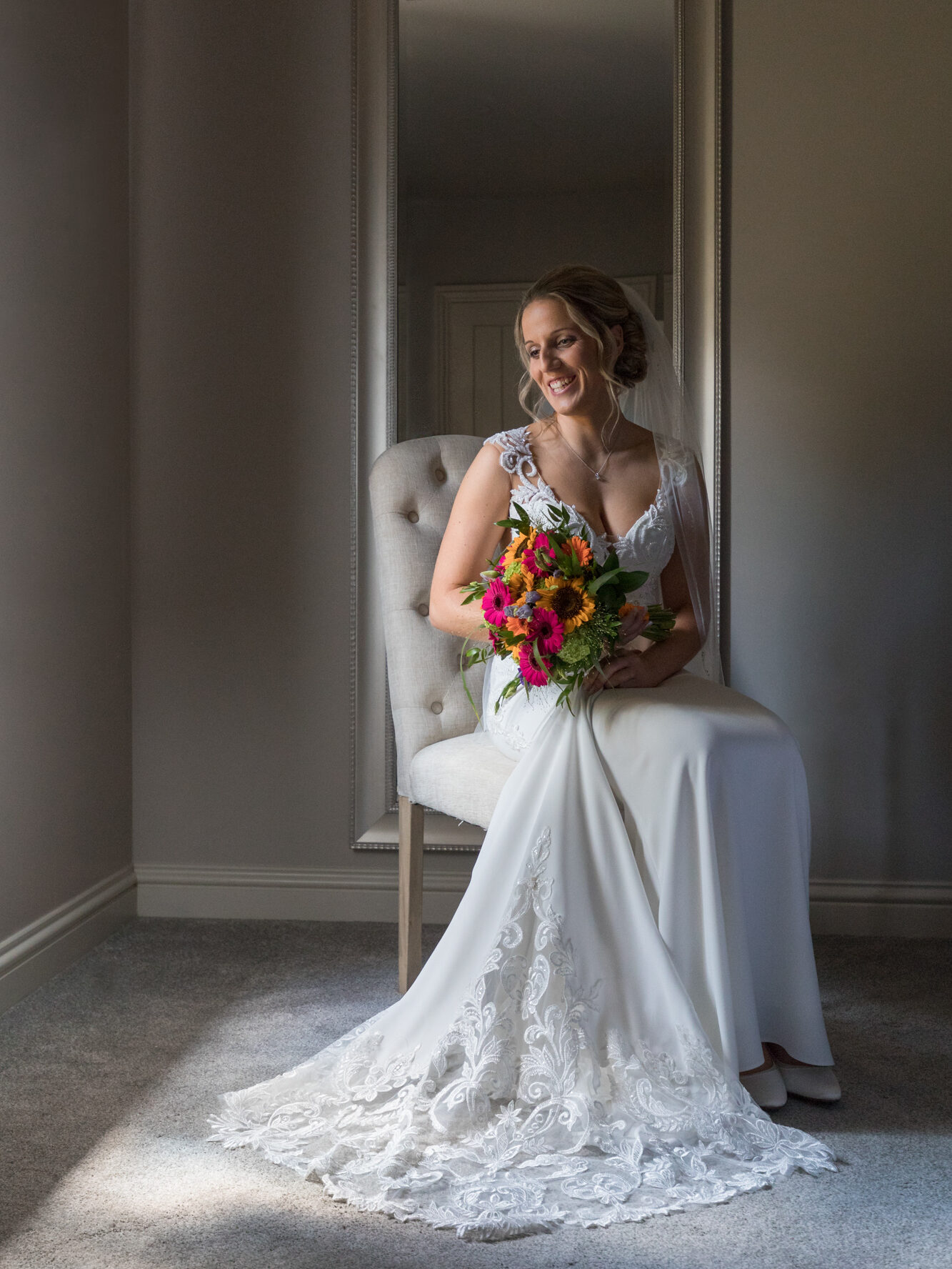 bride sat by window in bridal cottage at the barn at upcote