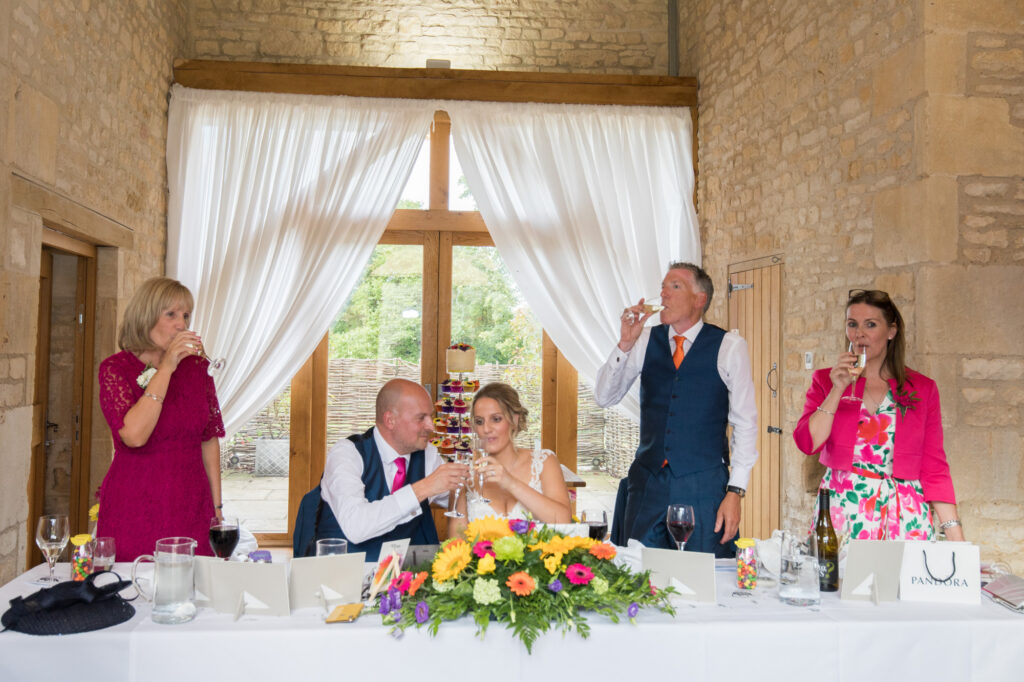 wedding day speeches the bride and groom toasting at the barn at upcote