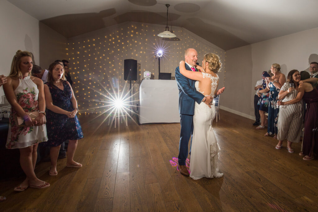 full length shot of bride and groom during first dance at the barn at upcote wedding venue