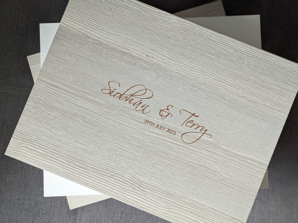 wedding album presentation box from graphistudio showing couples names on front