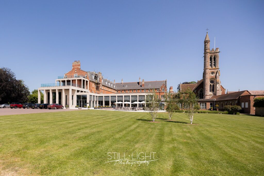 photograph of stanbrook abbey wedding venue with blue sky and bell tower