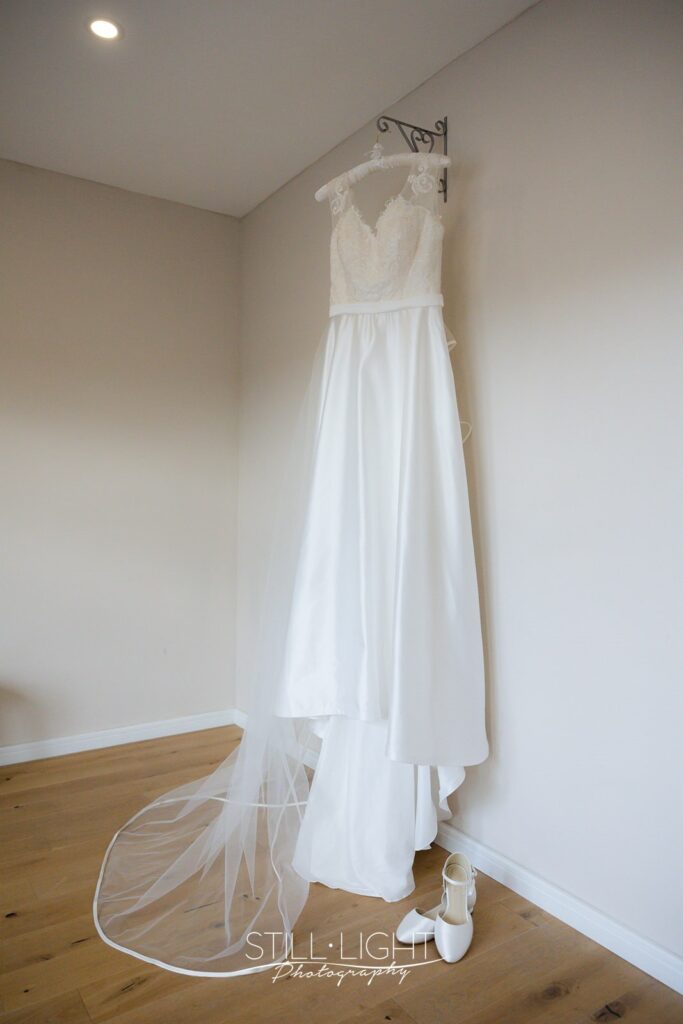 wedding dress hanging in hayloft at wootton park