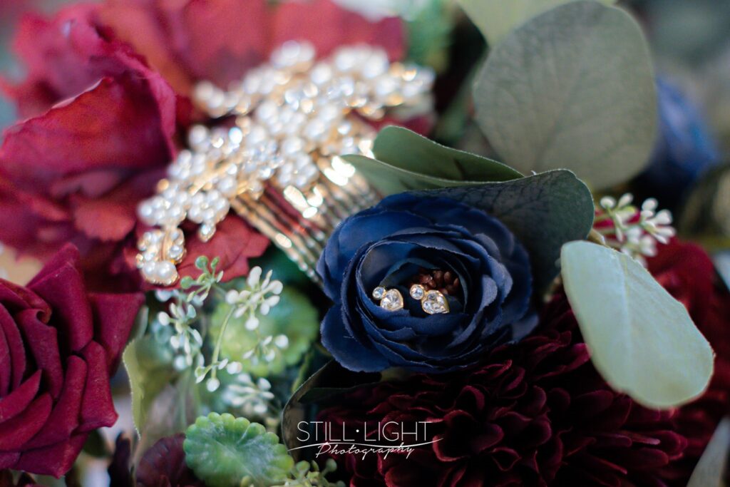 bride's wedding bouquet of flowers with reds and navy blue