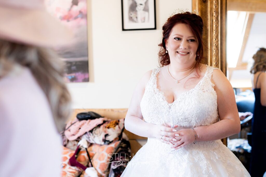 bride on her wedding day at redhouse barn wearing dress with lace and beading