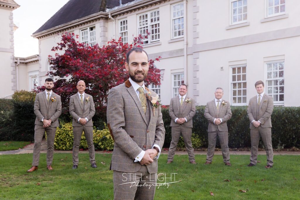 groom and groomsmen outside brockencote hall hotel on vintage wedding day