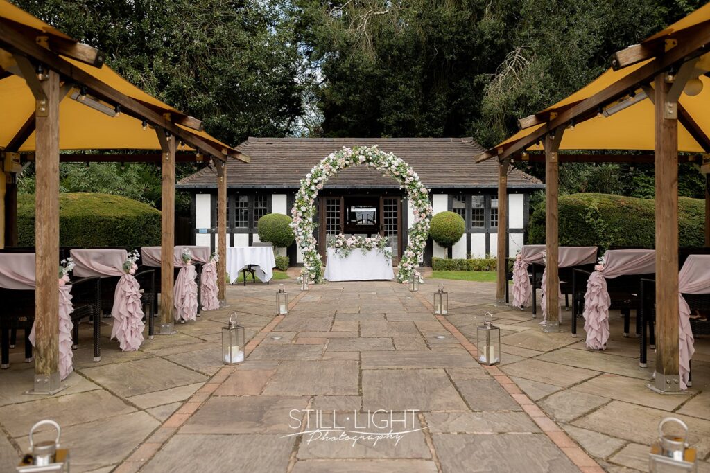 pump rooms at hogarths stone manor decorated with flower arch and pink chair covers from the wedding house