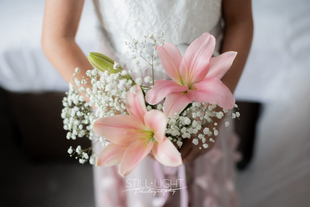lilies being held by the flower girl at intimate wedding day
