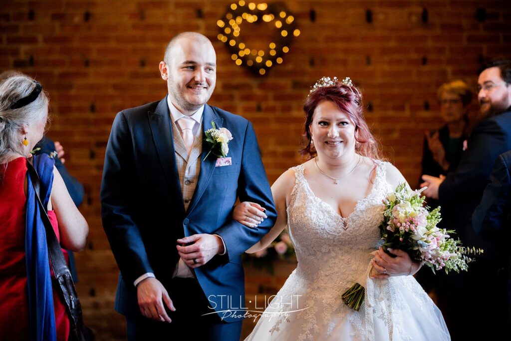 bride and groom standing together during wedding ceremony at redhouse barn