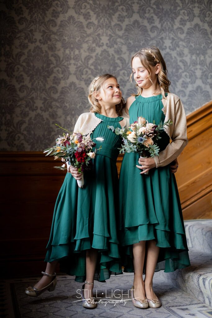 flowergirls on staircase at brockencote hall on vintage wedding day
