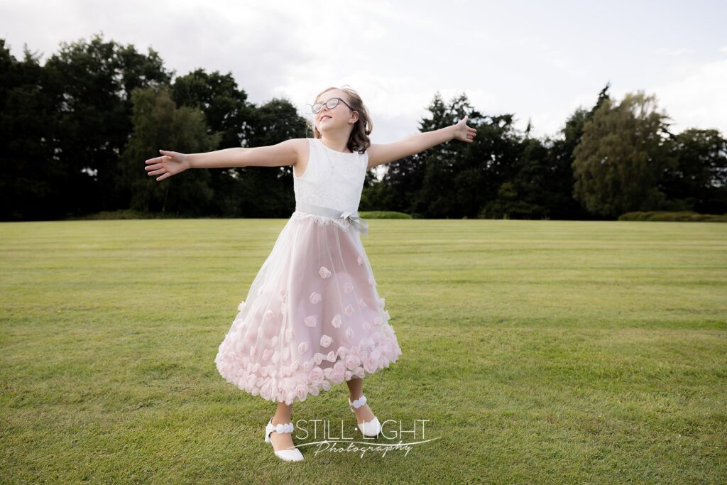 flowergirl dancing on the grass during relaxed drinks reception at hogarths stone manor