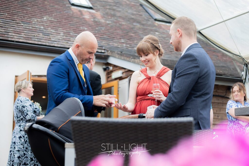 magician entertaining wedding guests during drinks reception