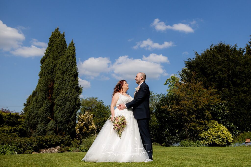 bride and groom standing in gardens at redhouse barn