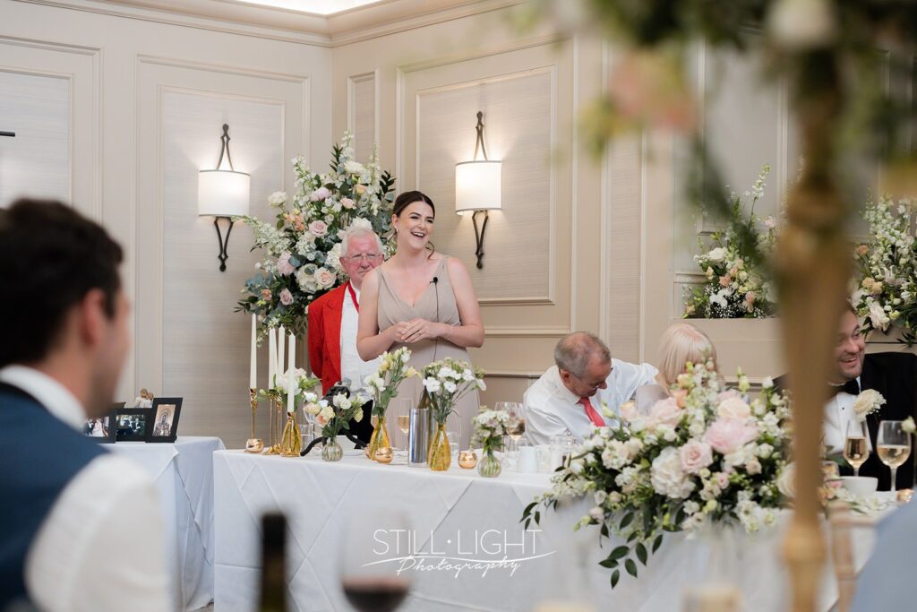 maid of honour standing giving speech at top table in st anne's on summer wedding day