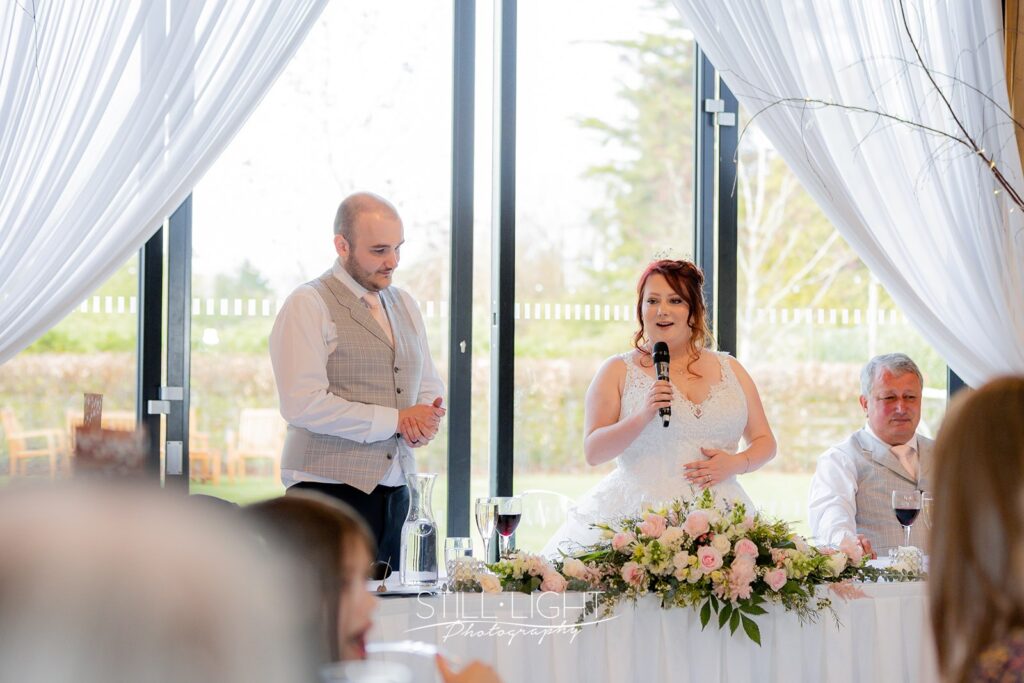 bride and grooom making shared speech on their wedding day at redhouse barn