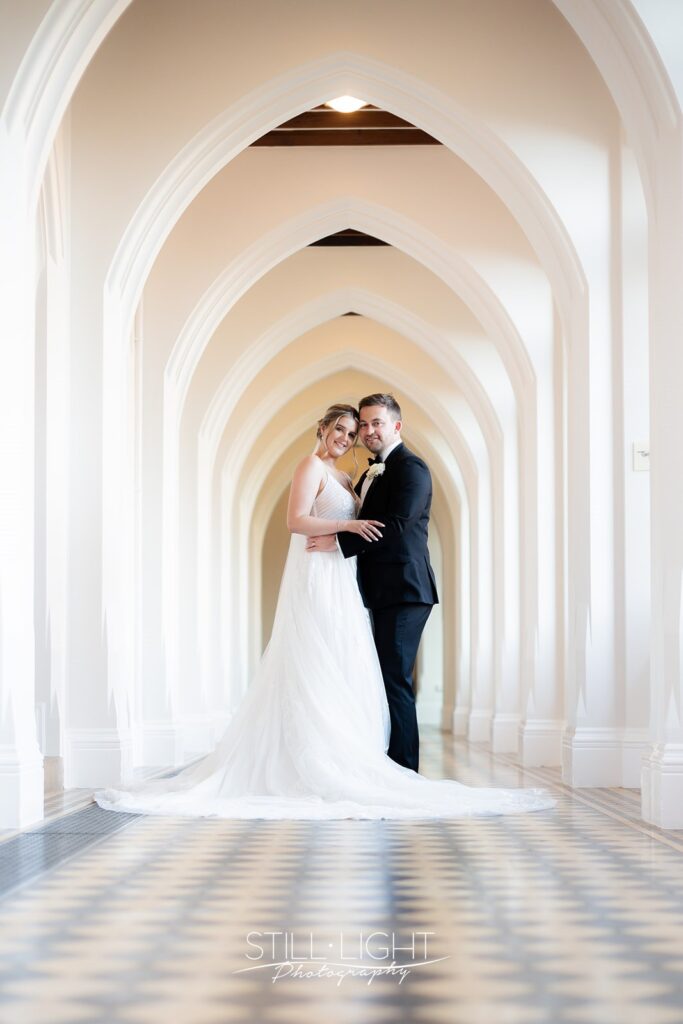 bride and groom during couple photos in the cloisters at stanbrook abbey hotel