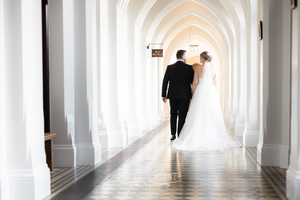 bride and groom during couple photos in the cloisters at stanbrook abbey hotel