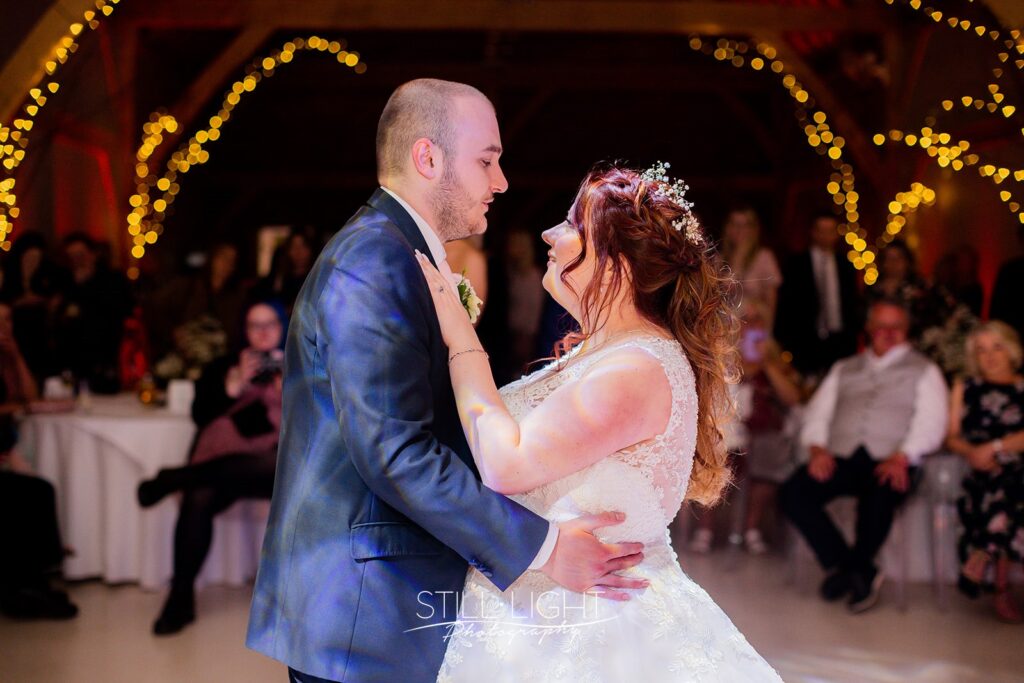 bride and groom having their first dance on dancefloor at redhouse barn