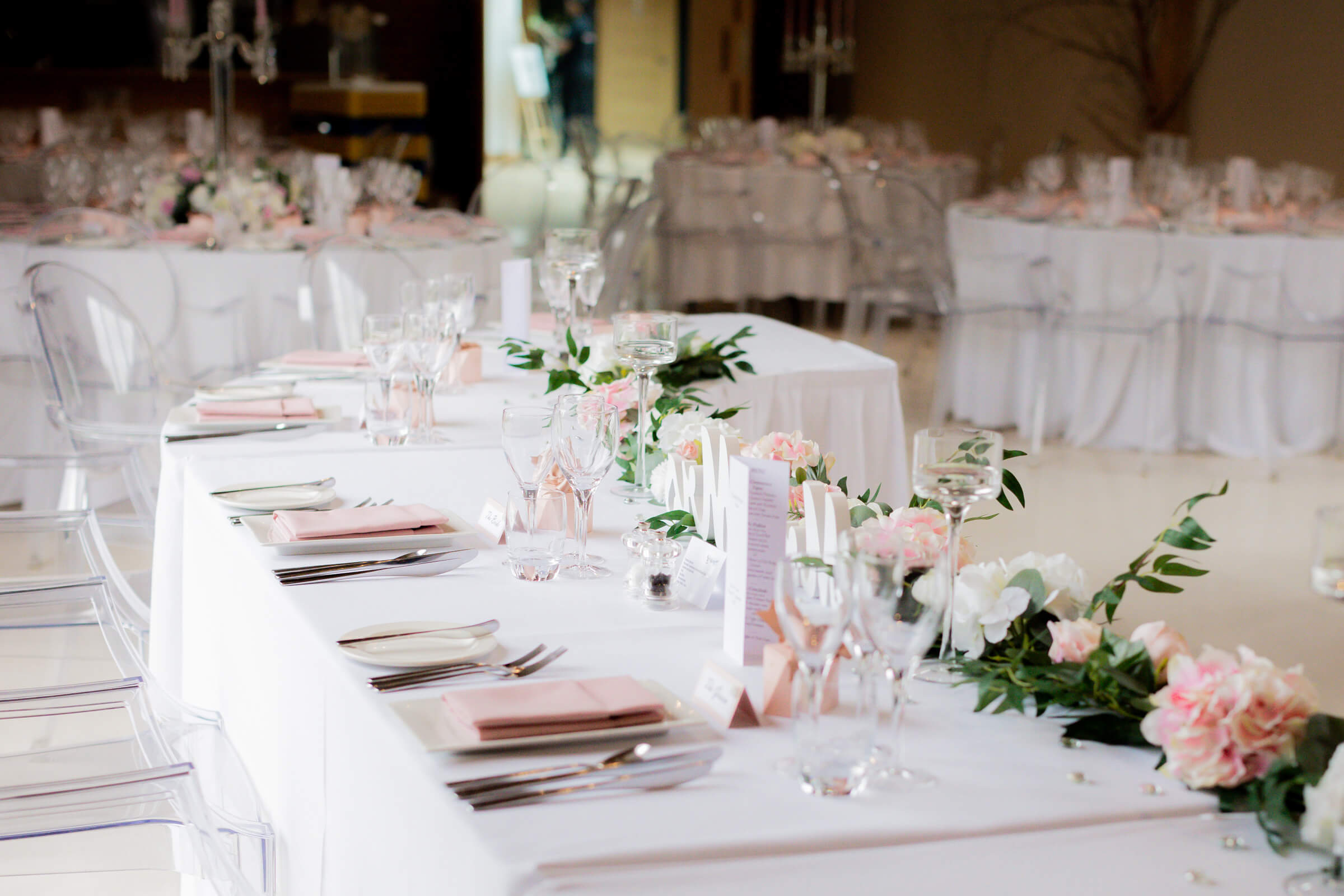 redhouse barn wedding breakfast room with white table linen and pink flowers
