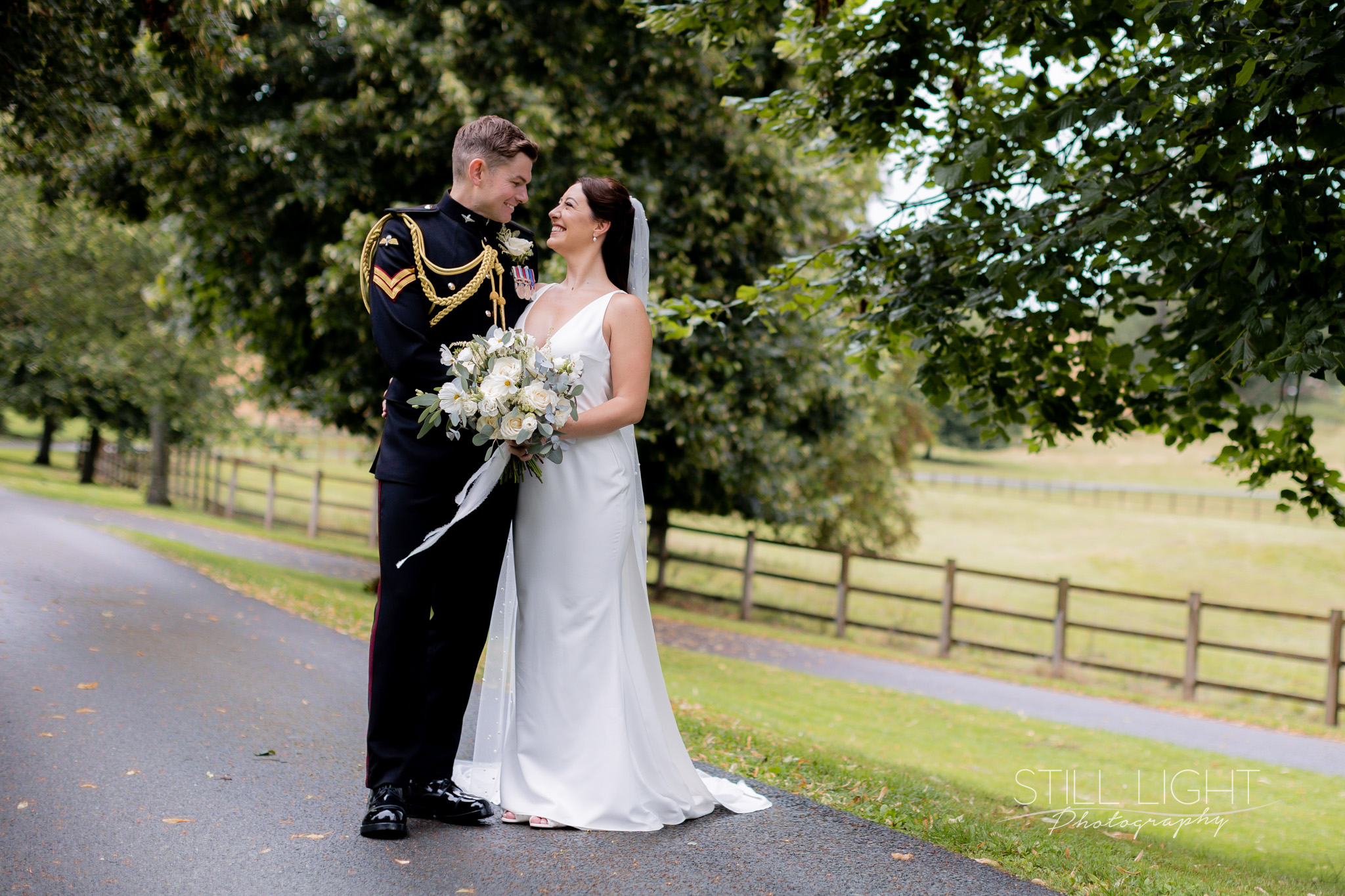 bride and groom dressed in military usiform on their wedding day at arley house & gardens