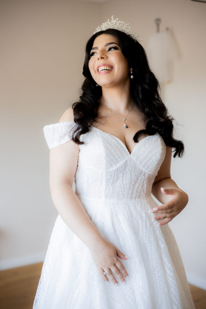 portrait of stunning bride smiling away from camera on her wedding day at wootton park