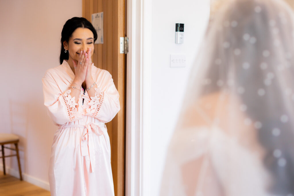 bride's sister looking surprised during bride reveal on wedding day at wootton park