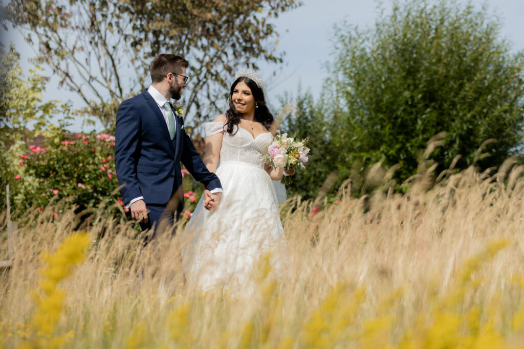 bride and grom walking during couple photo session in grounds of wootton park