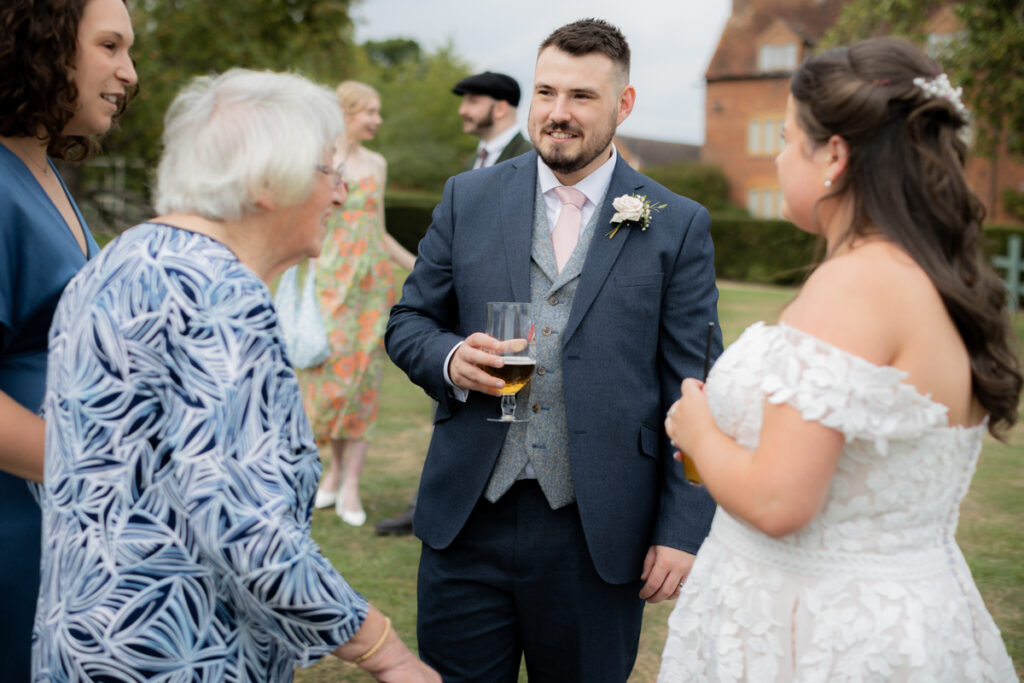 groom chatting during drinks reception at bordesley park