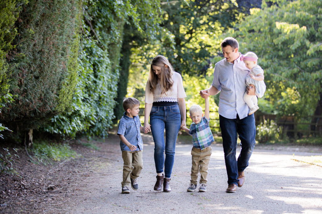 family of 5 walking towards camera  during an outdoor family photography session in worcestershire