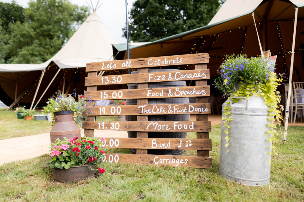 rustic pallet wedding day sign outside tipi marquee