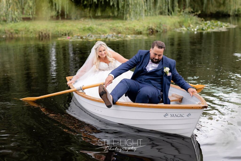 groom wobbling during fun rowing boat experience on wedding day at wootton park
