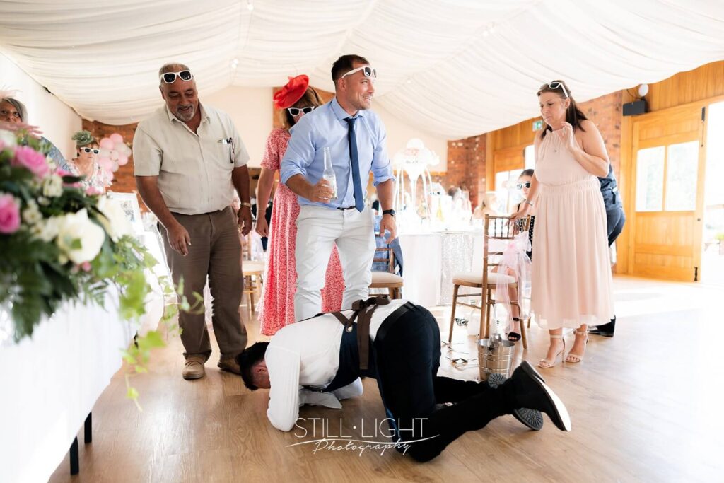 singing waiter falls as guests look on during wedding breakfast at wootton park
