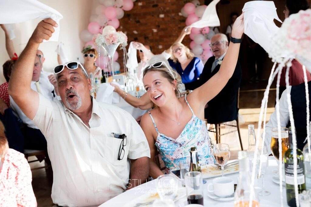 guests sing along to singing waiters during wedding breakfast at wootton park