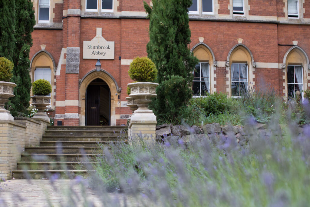stanbrook abbey hotel entrance with lavender in foreground, a dog friendly wedding venue