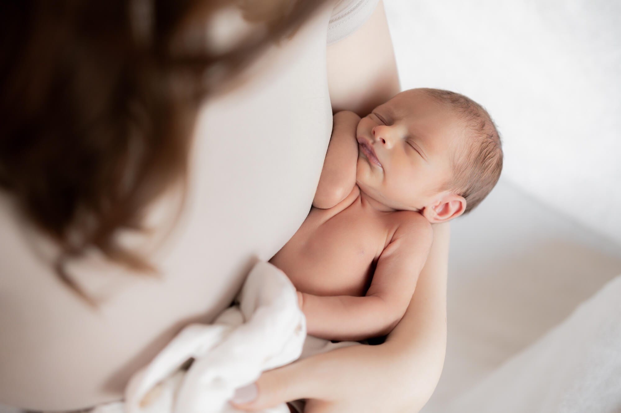 newborn baby in mothers arms taken from above